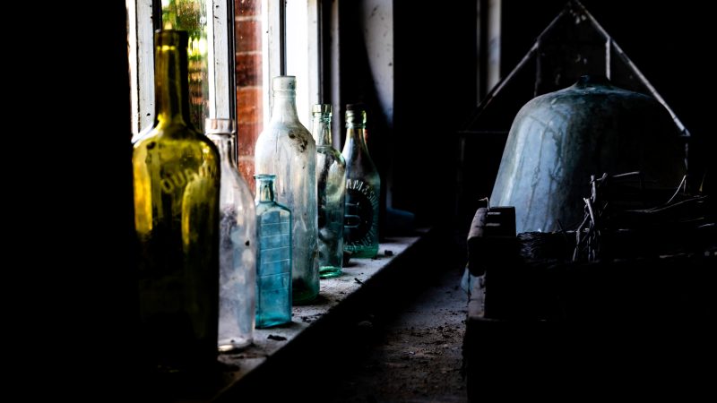 Colourful vintage bottles on window sill